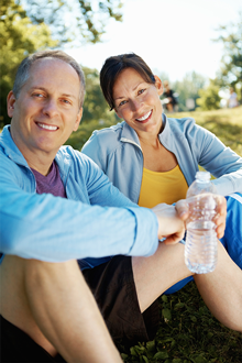 couple sitting and drinking water outside