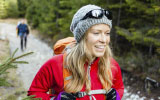 woman hiking with friend on a trail