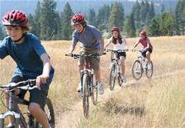 kids riding bikes on a trail