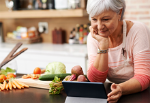 woman using tablet and cooking