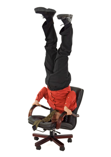 man doing a headstand in his office chair