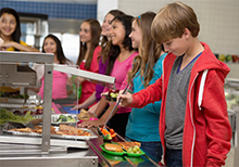 kids getting food in lunch line at school