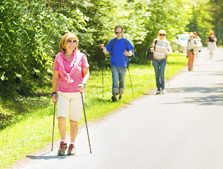 woman and group of people nordic walking