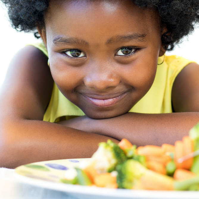 Girl with a plate of healthy vegetables
