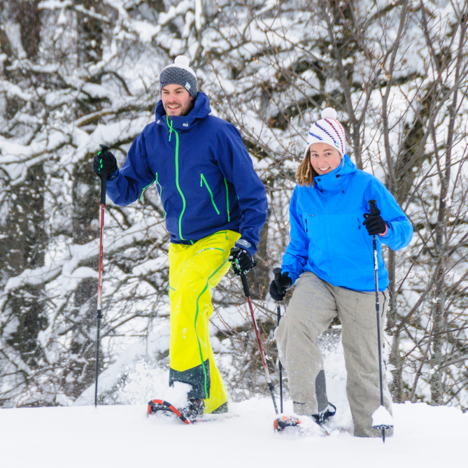 man and woman snowshoeing